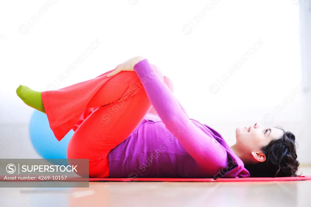 Pregnant woman performing prenatal exercises.