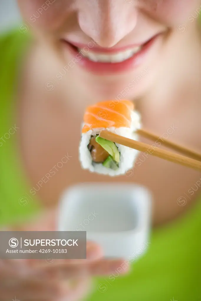 Woman eating sushi.