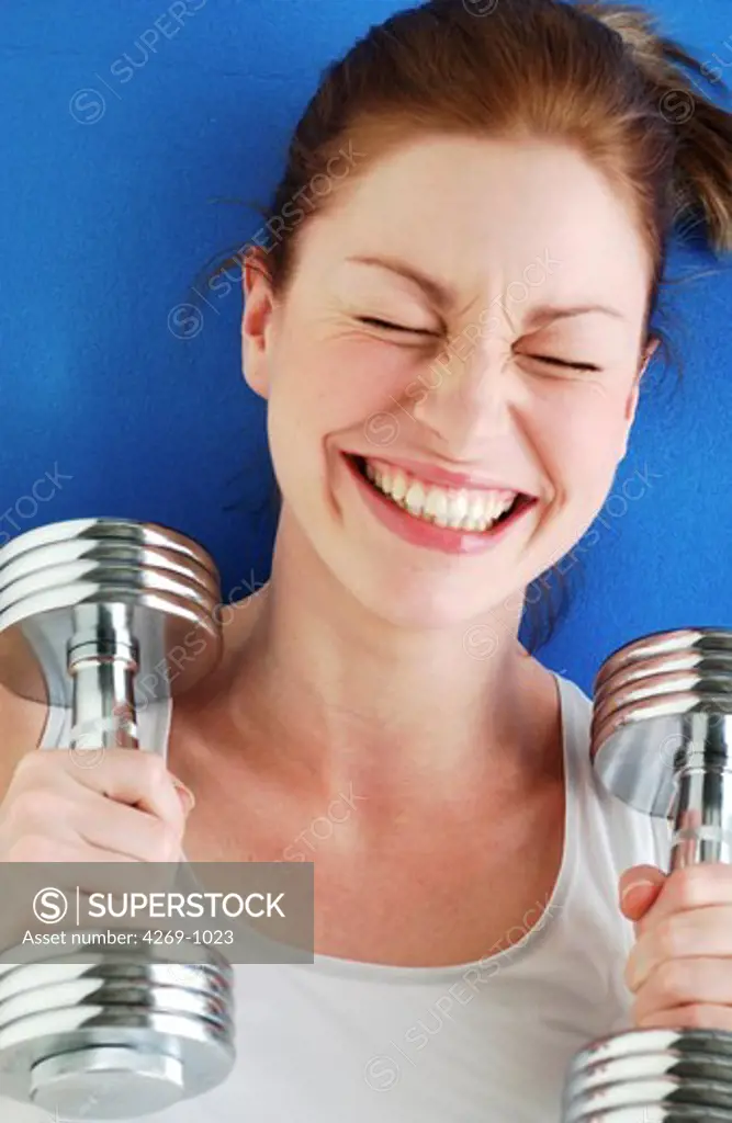 Woman working out with dumbells.