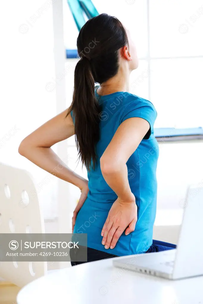 Woman suffering from lumbar pain.