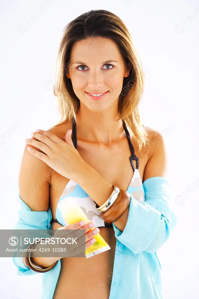 Woman applying sunblock.
