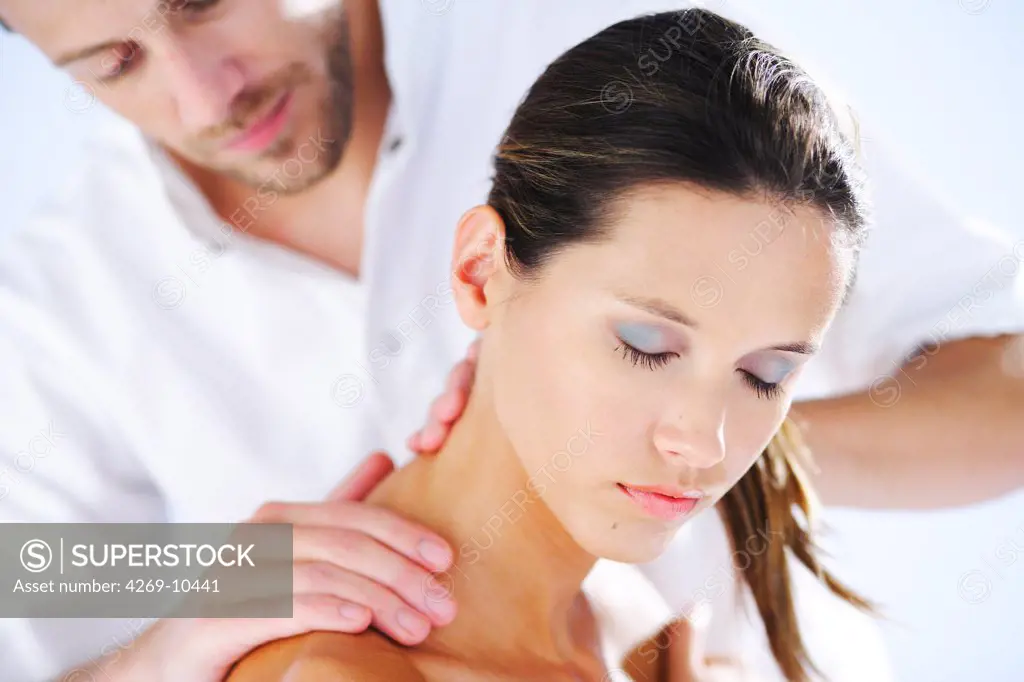 Woman's neck being manipulated by osteopath.