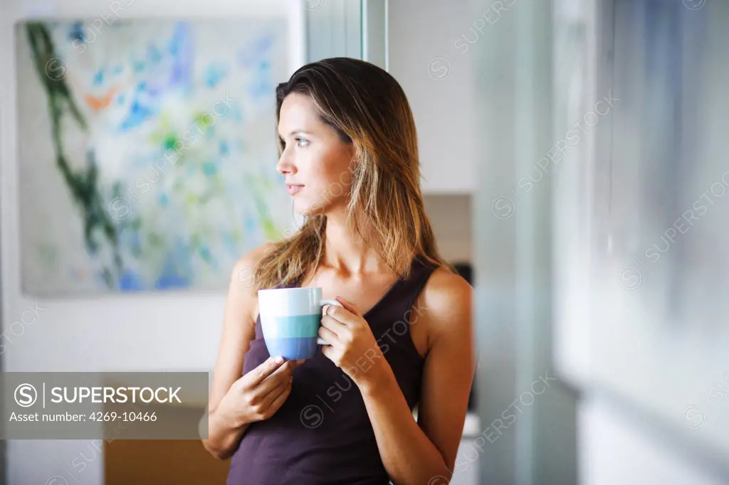 Woman drinking a hot beverage.