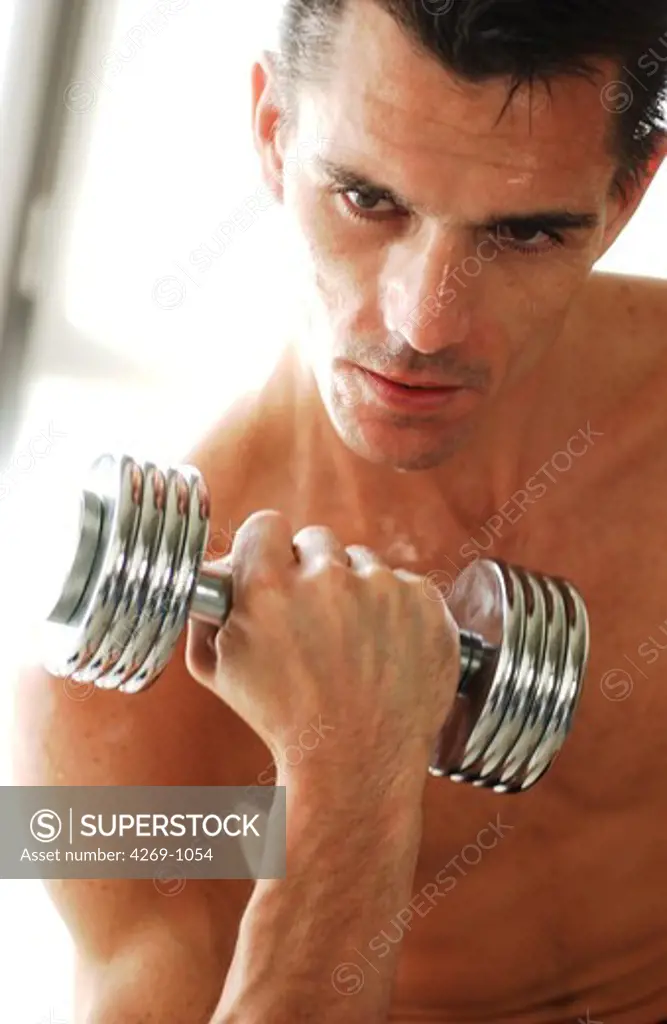 Man exercising with dumbells.