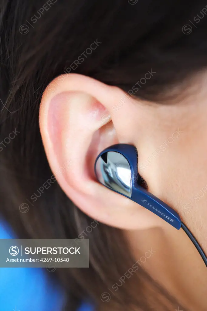 Woman listening music with earphone.
