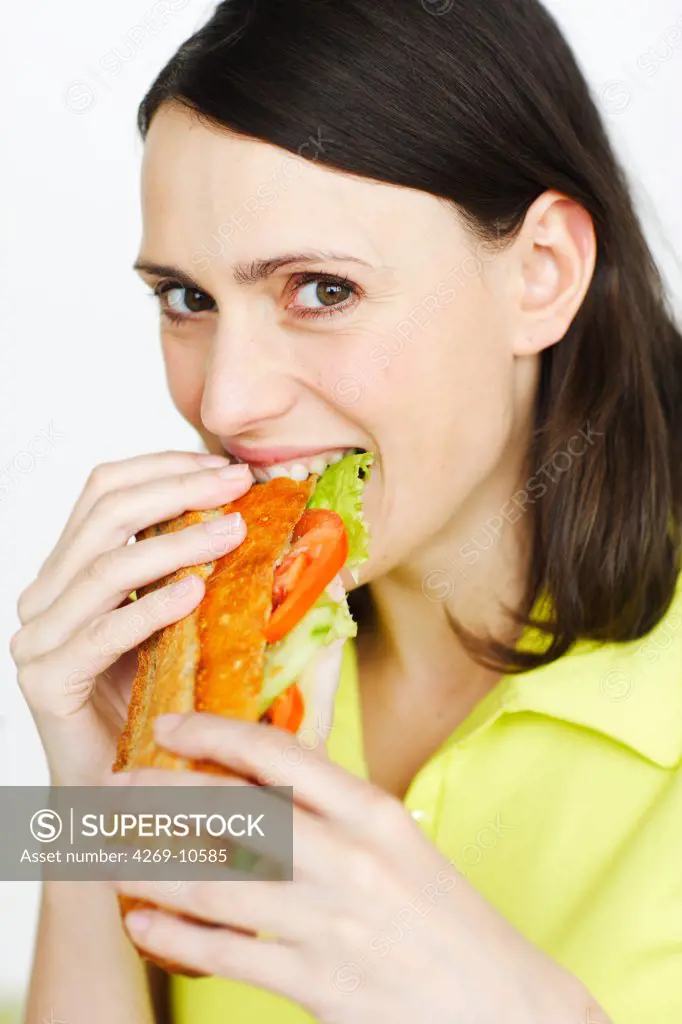 Woman eating a sandwich.