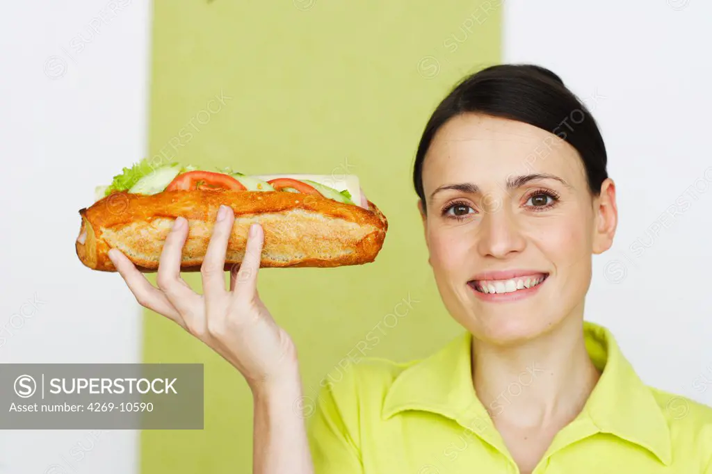 Woman eating a sandwich.