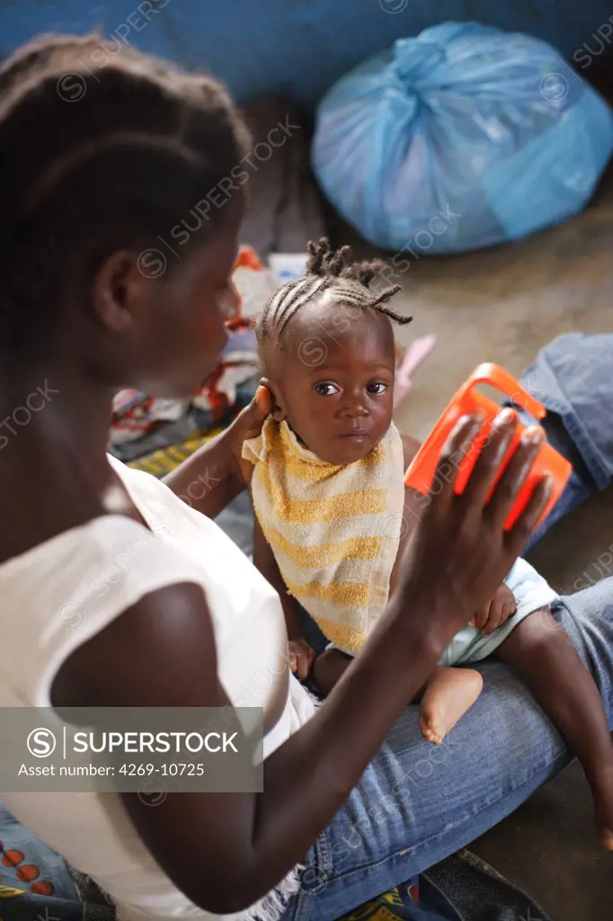 Young mother and her child suffering from malnutrition in a Therapeutic Feeding Center in Monrovia, Liberia, implemented by Action contre la Faim (ACF), an international non-governmental organisation (Action against Hunger).
