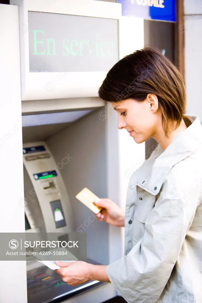Woman withdrawing money from a cash machine.