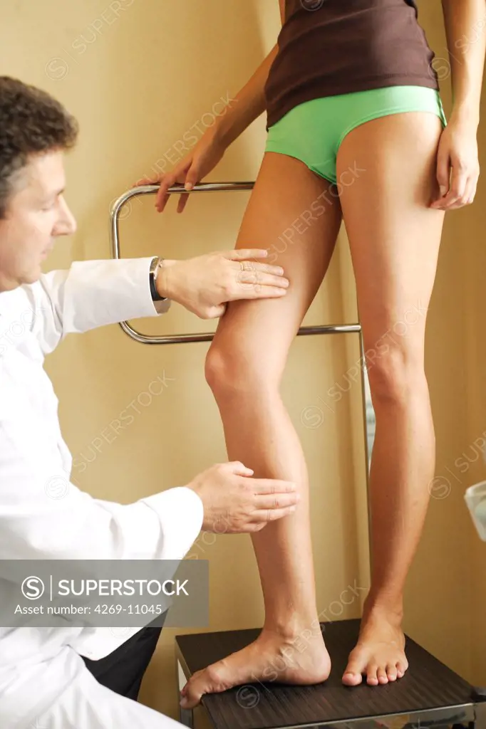 Doctor examining the legs of a patient.
