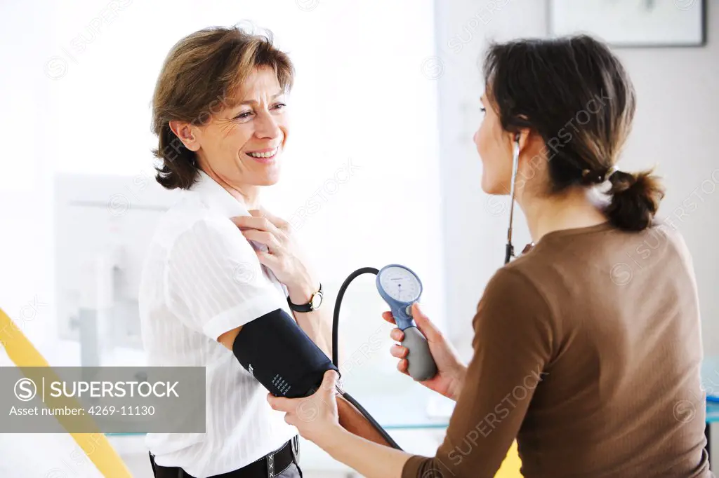 Doctor checking the blood pressure of a patient.