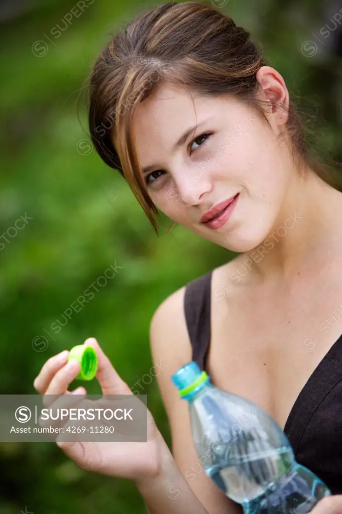 Teenager drinking mineral water.