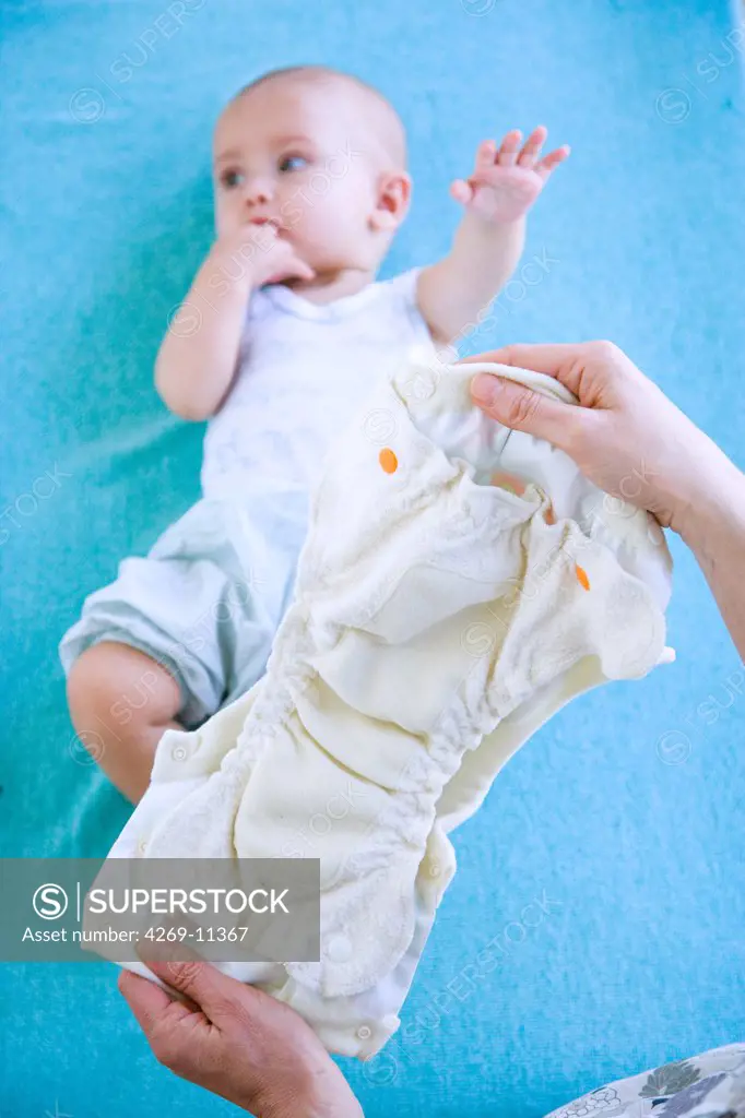 7 months old baby with a washable diaper made with organic material.
