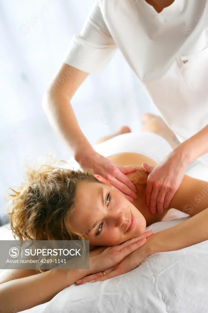 A woman having her back massaged. Massage therapy is commonly used to relieve tension. Various techniques have been used for centuries to heal the body as well as the mind.