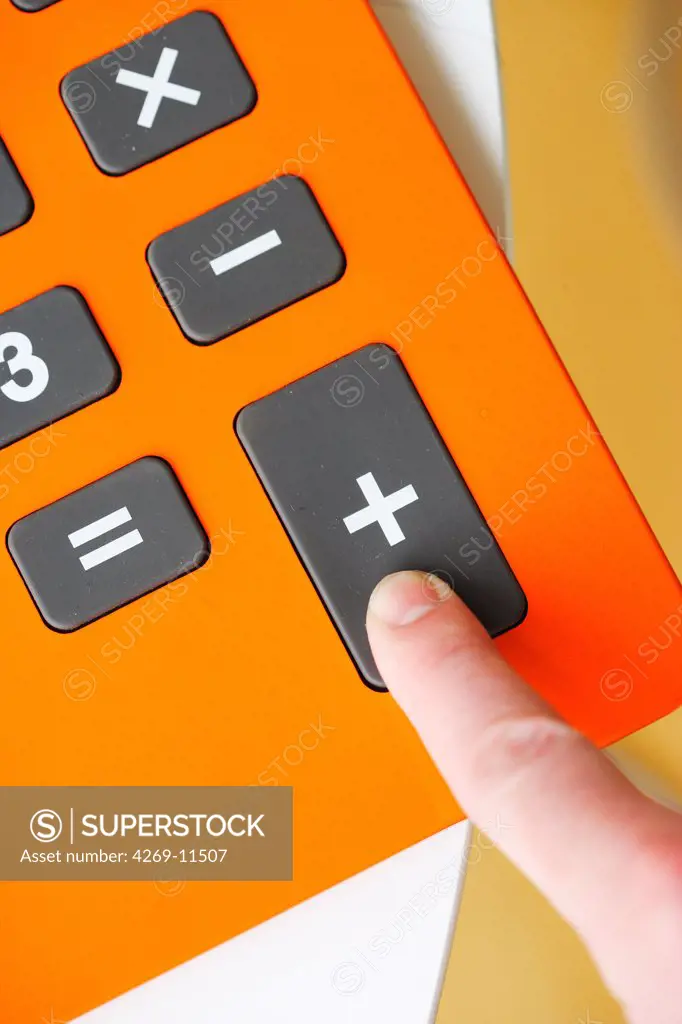 Finger pushing calculator buttons.