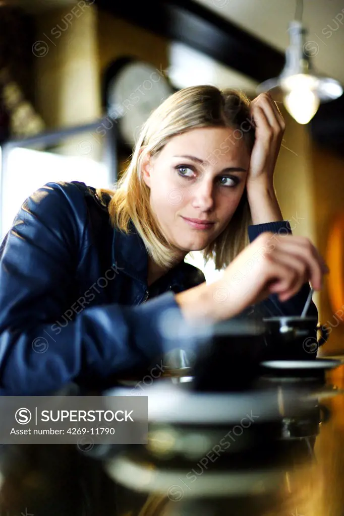 Woman having a coffee in a café.