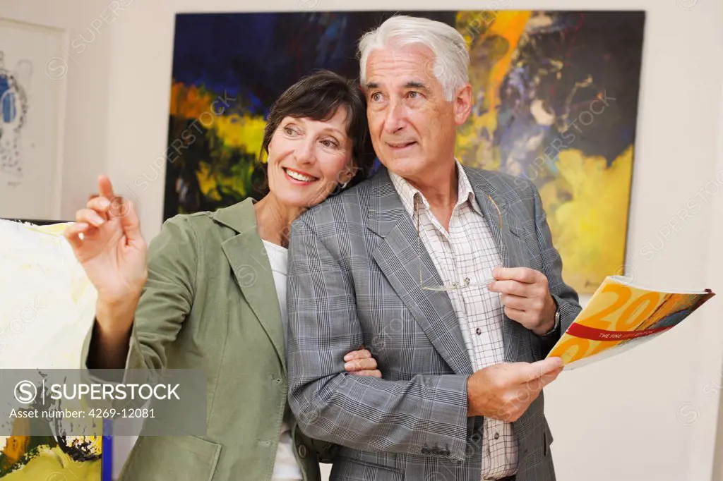 Senior couple visiting modern art gallery.