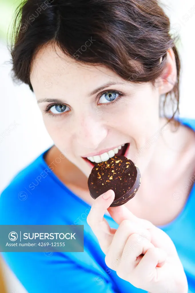Woman eating chocolate.