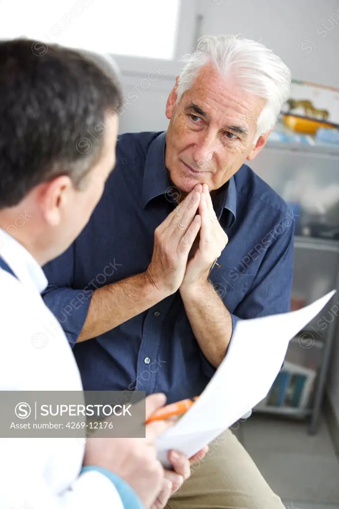 Doctor talking with a senior patient during medical consultation.