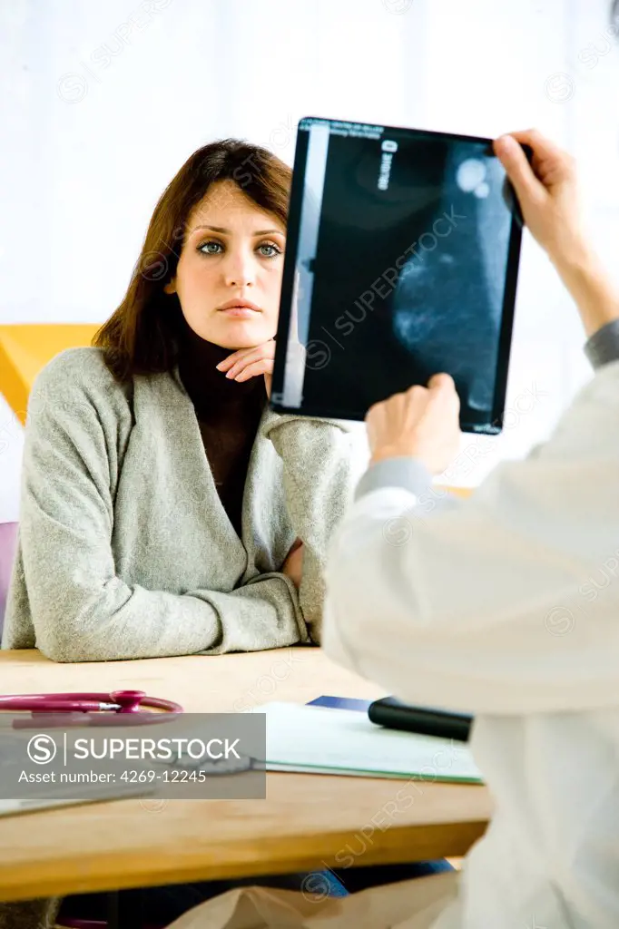 Doctor examining the mammograph (breast X-ray) of a patient for breast cancer screening.