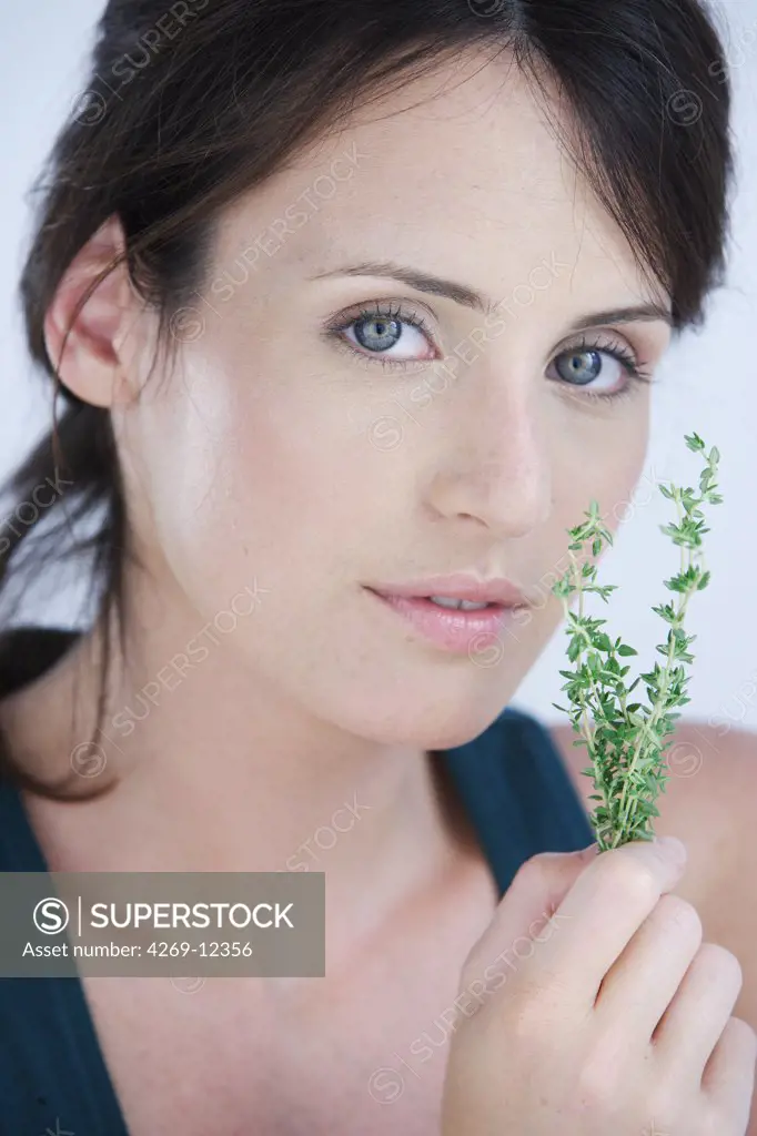 Woman inhaling thyme fragrance.