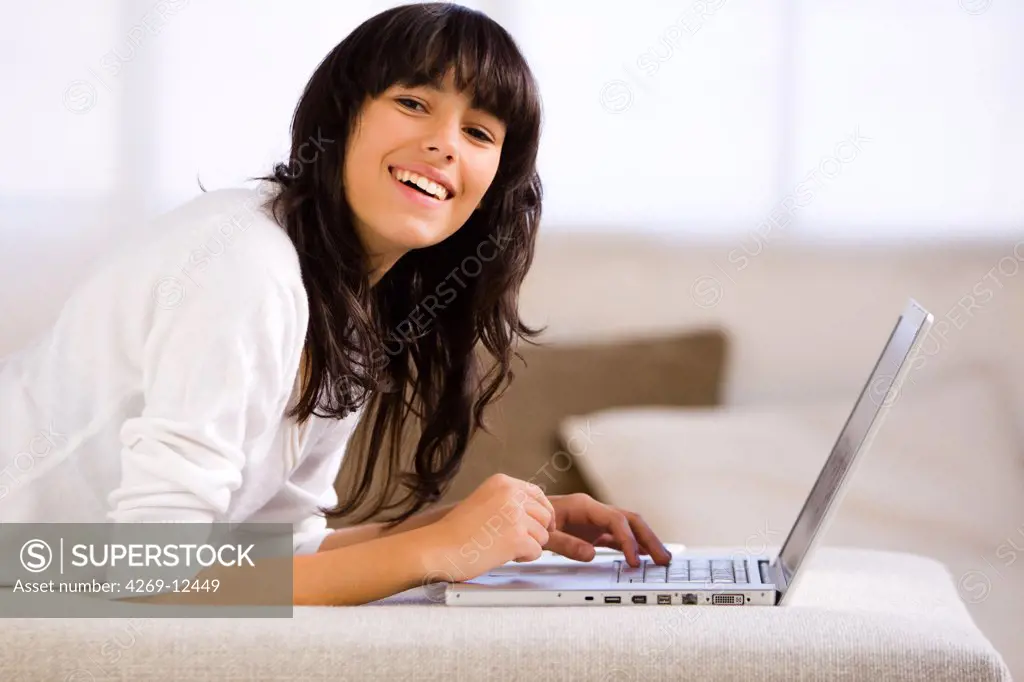 Teenage girl using a laptop computer.
