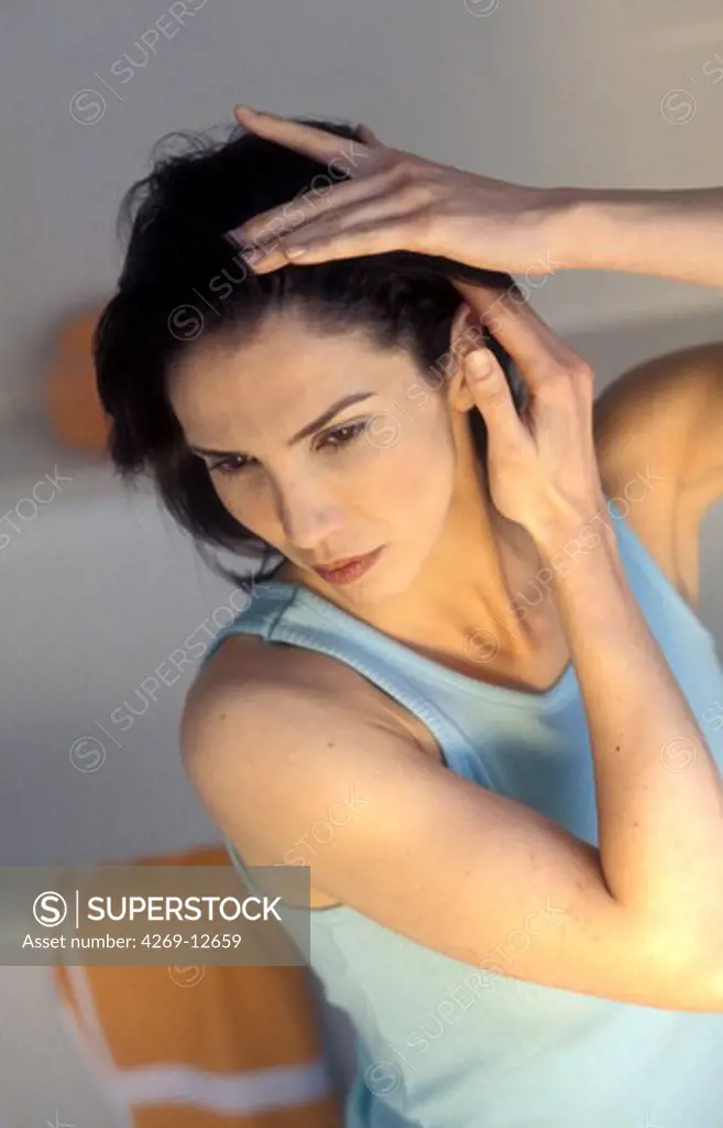 Woman inspecting her scalp.