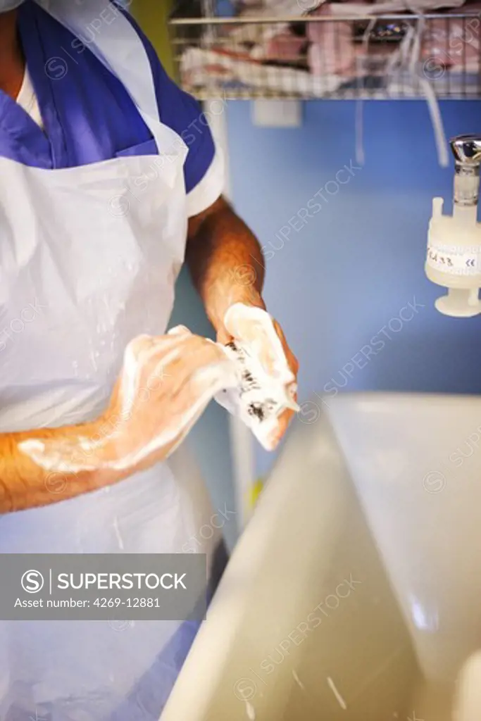 Medical staff washing hands in operating theater.