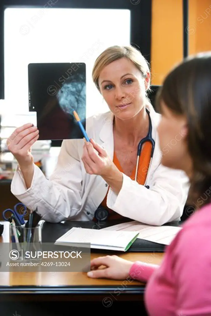 Doctor commenting on a mammography to her patient affected by breast cancer.