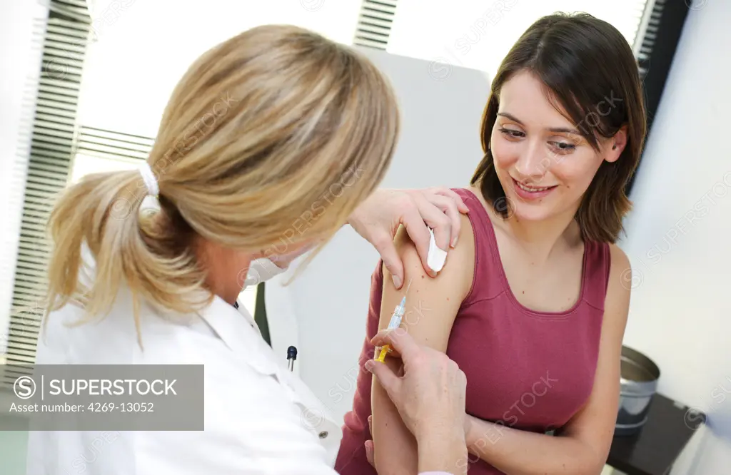 Doctor giving a patient vaccination against hepatitis B.