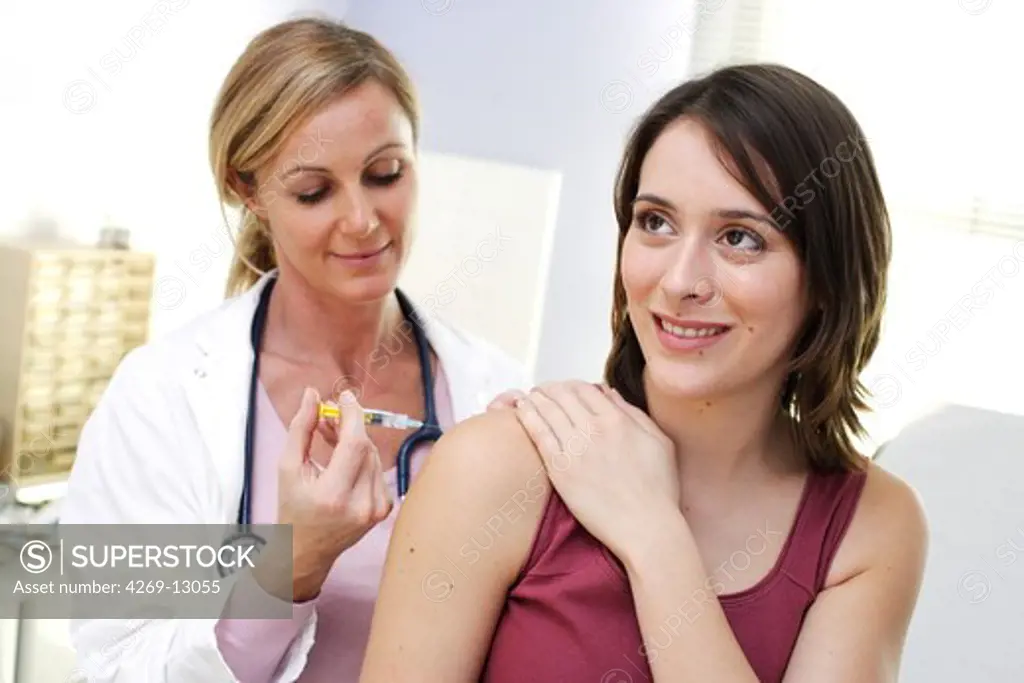 Doctor giving a patient vaccination against hepatitis B.