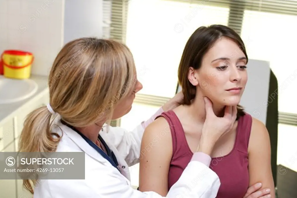 Doctor examining the thyroid gland of a patient.