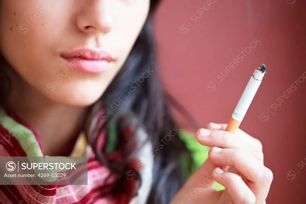 Teenage girl smoking cigarette.
