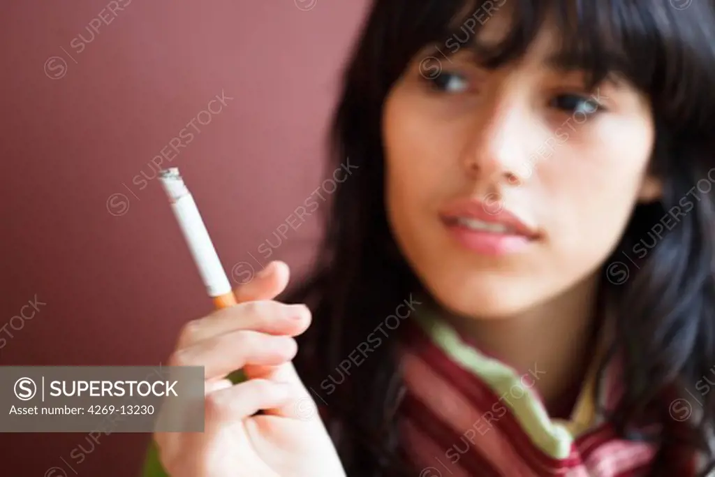 Teenage girl smoking cigarette.
