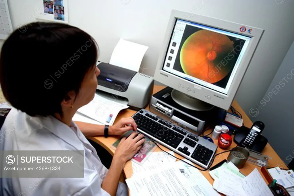 Department of ophthalmology of Lariboisière Hospital, Paris, France. Dr Pascale Massin, ophthalmologist, is interpreting fundus camera images of patient affected by diabetic retinopathy. She is also coordinator of the OPHDIAT network : digitized photographies of the fundus of the eye are realized by a technician (not a doctor) with a non-mydriatic retinograph and then teletransmitted to ophthalmologists to be interpreted in different remote hospitals. The screening of this pathology and the care