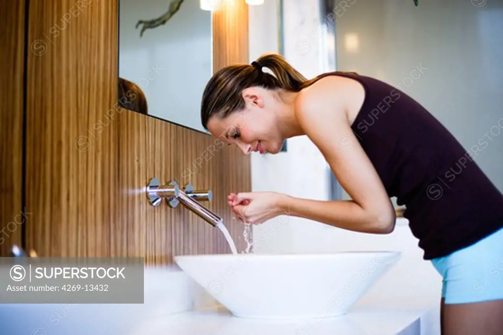 Woman washing her face.