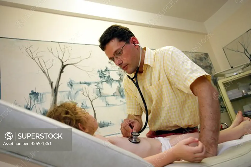 General practitioner examining the chest of a 3 years old girl with a stethoscope during consultation.