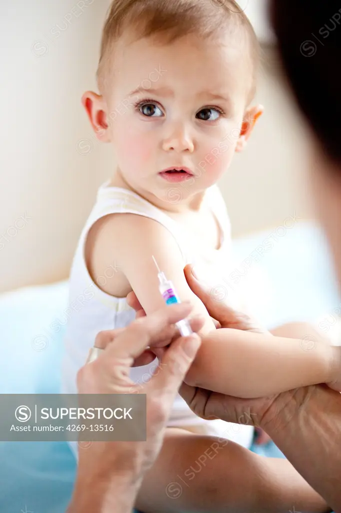 14 months old baby receiving vaccination.