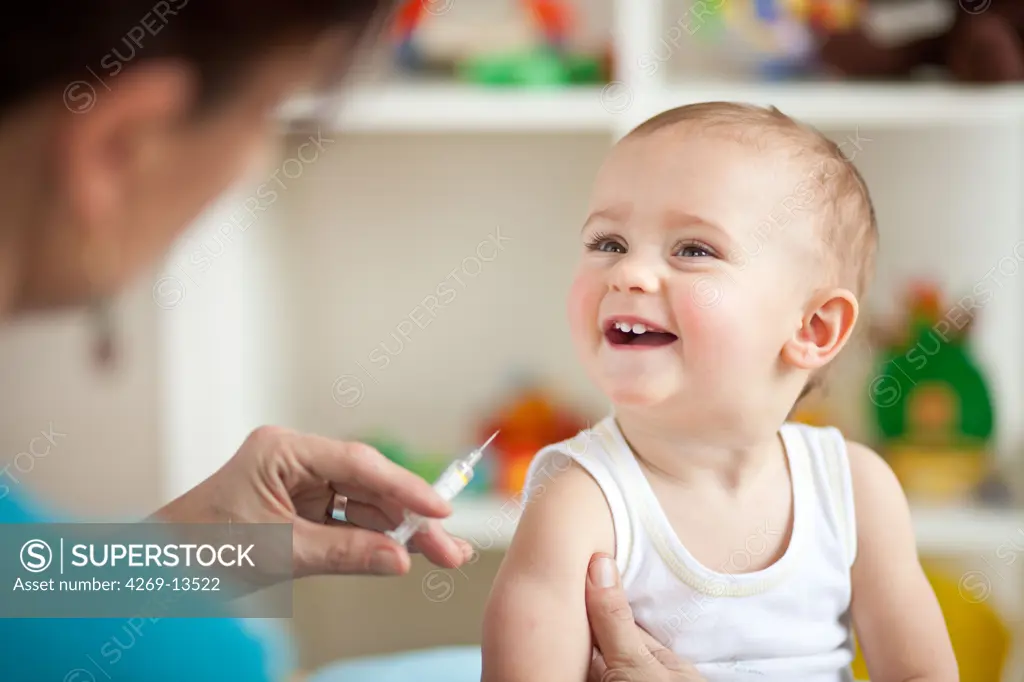 14 months old baby receiving vaccination.