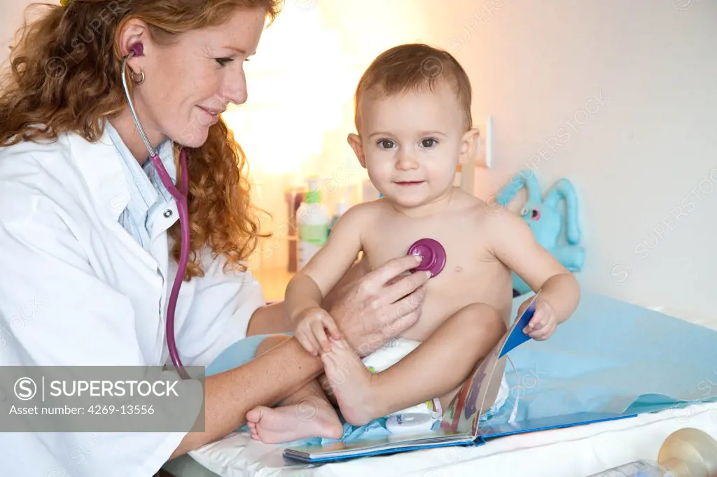 Doctor examining a 15 months old baby girl with a stethoscope.