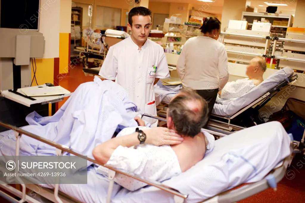 Nurse attending to a patient. Emergency department, Limoges hospital, France.