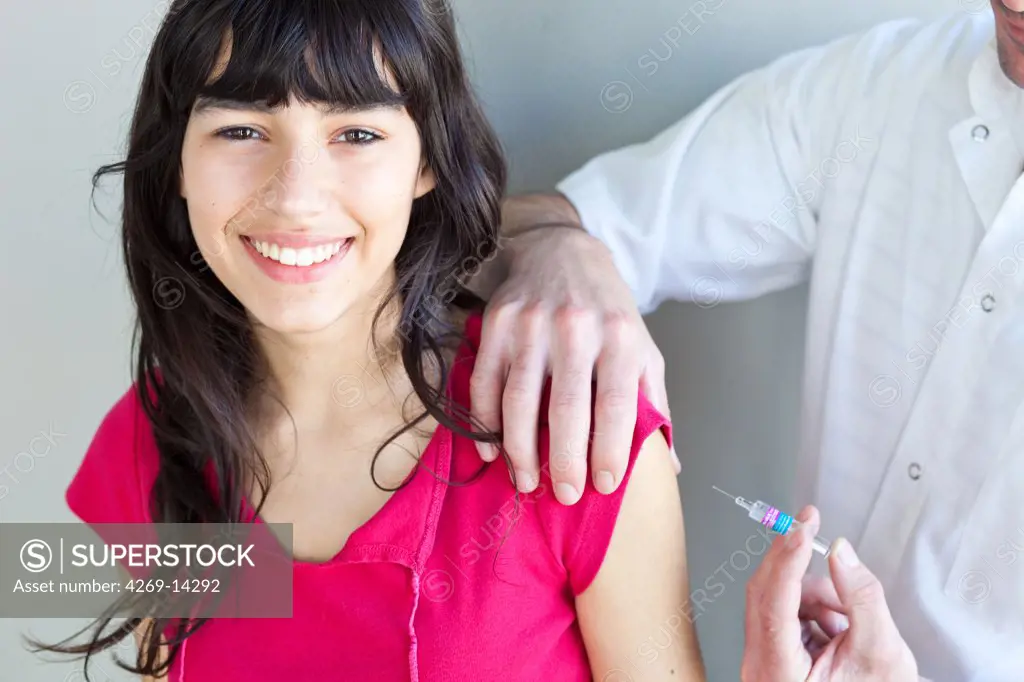 Teenage girl receiving vaccination against hepatitis B.