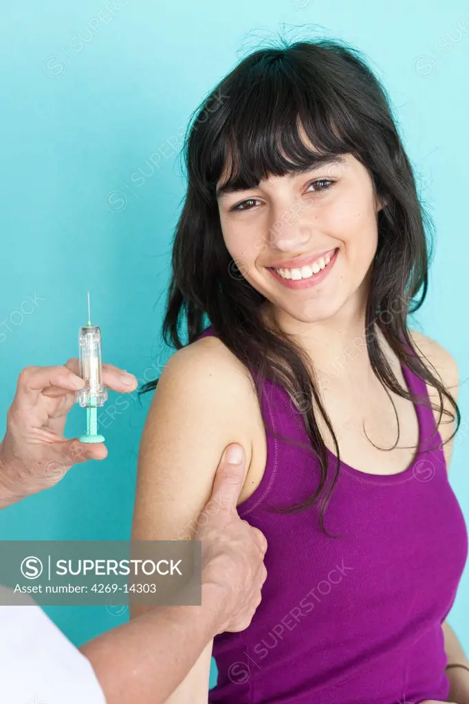 Teenage girl receiving Gardasil vaccination. Gardasil is a vaccine against certain types of the human papillomavirus (HPV) responsible for cervical cancer.