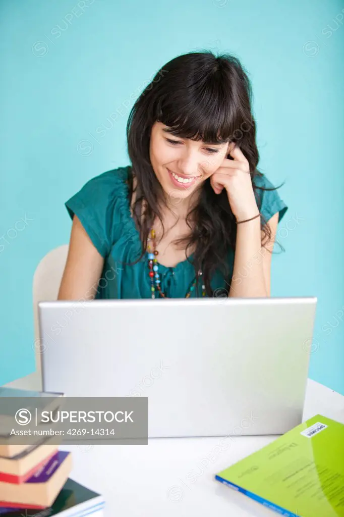 Young woman studying and using her laptop computer.