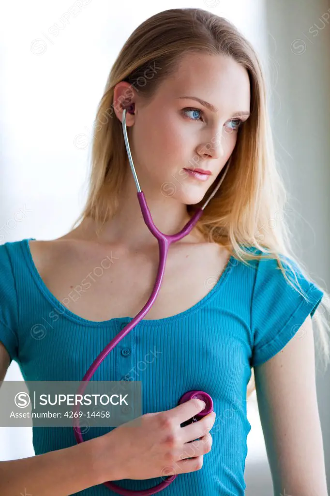 Woman checking her hearbeats with a stethoscope, illustration for self-monitoring.