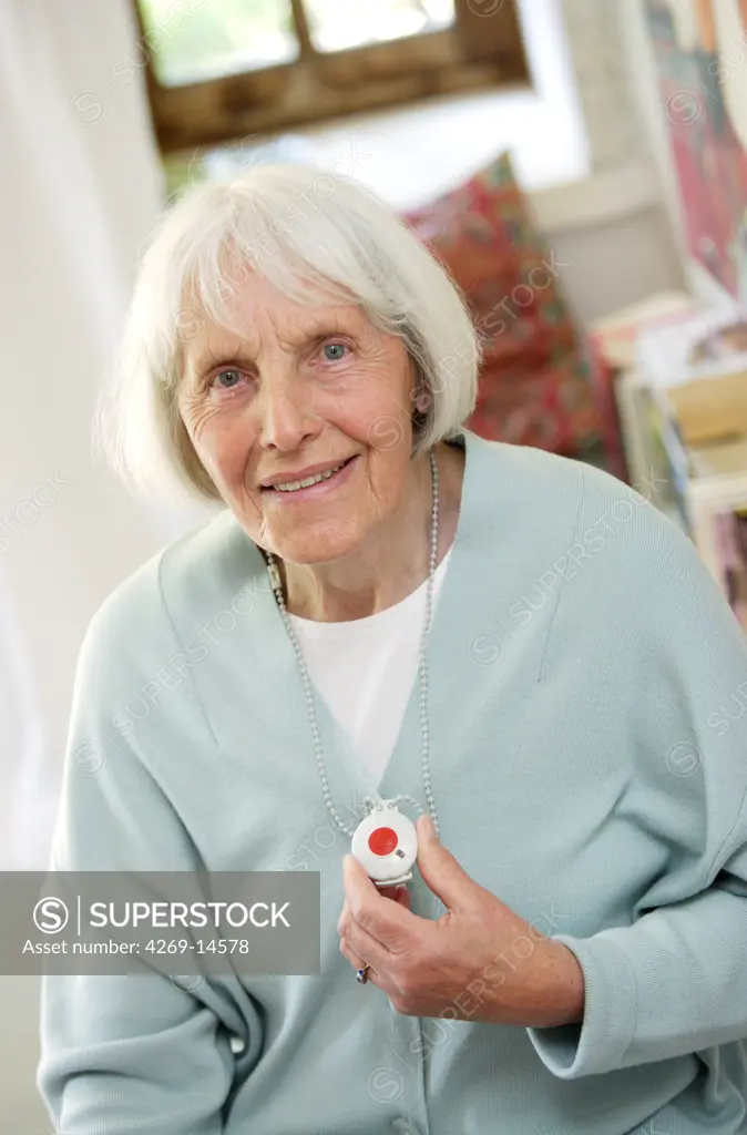 Elderly woman wearing a remote assistance unit.