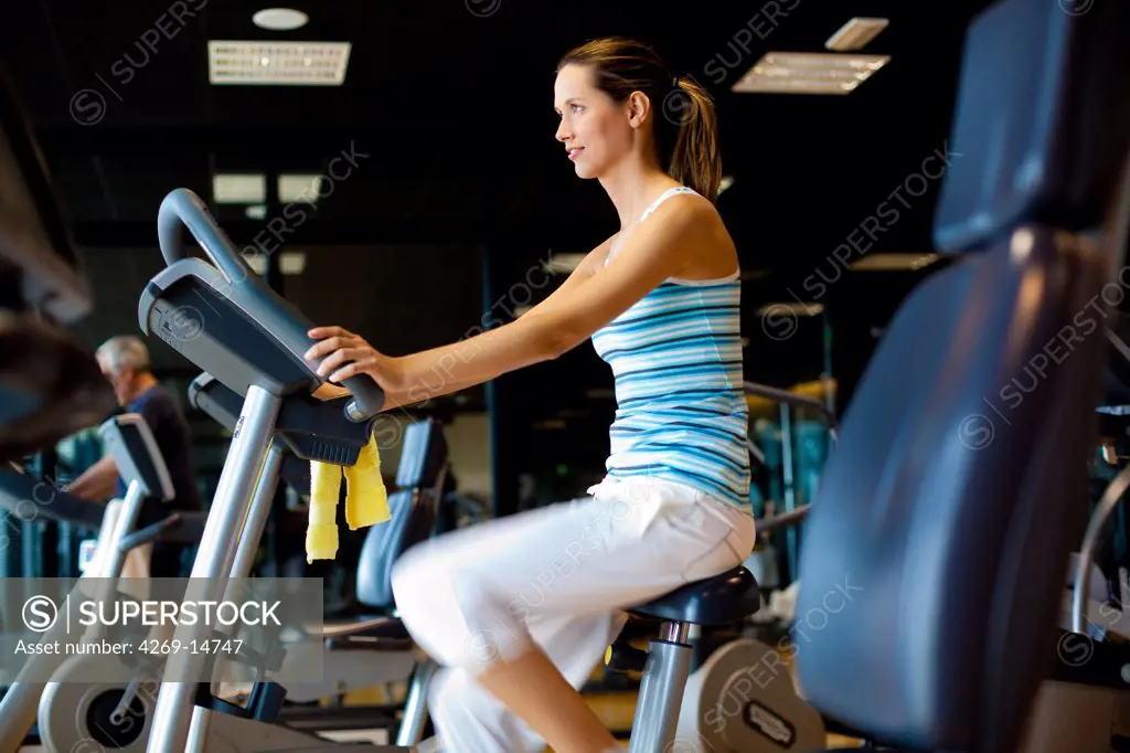 Woman on exercise bike at the gym.