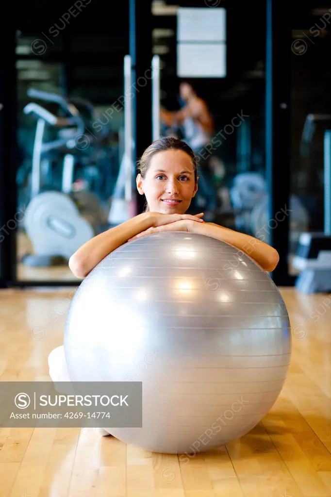 Woman with excercise ball in a gym.