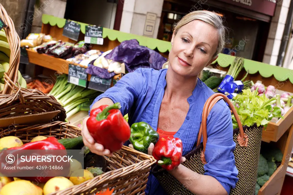 Woman buying fruits in organic market.