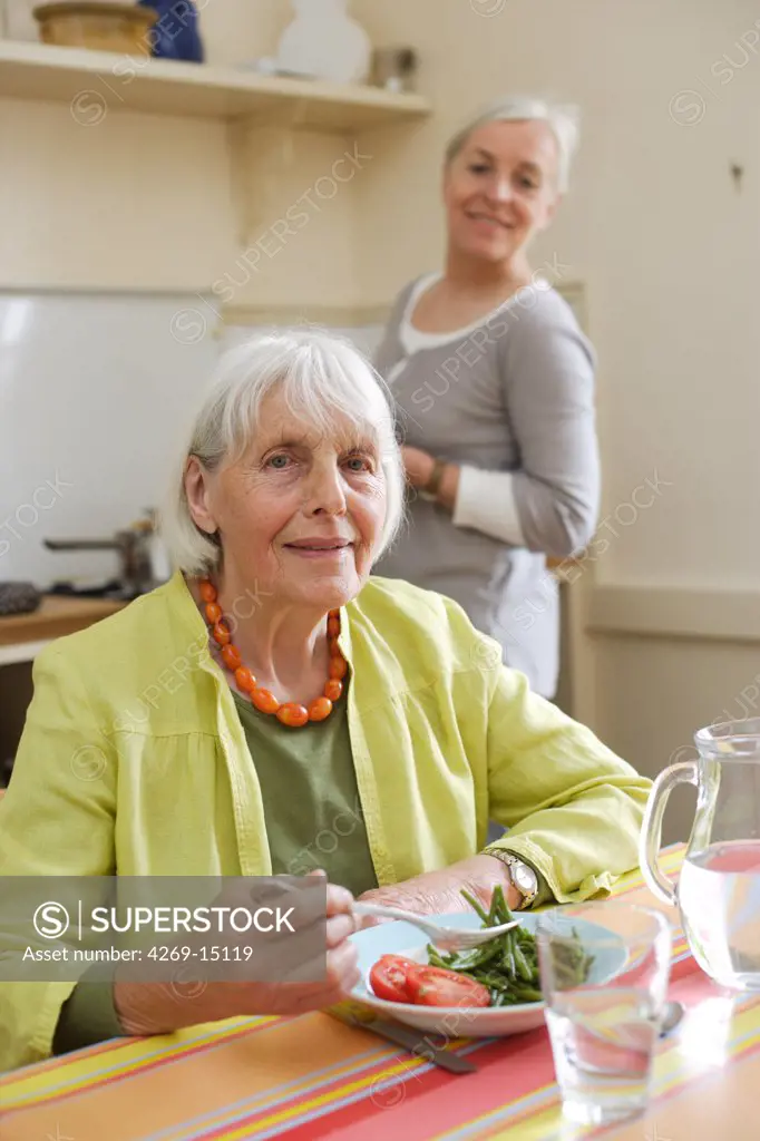 80 years old woman having lunch at home.